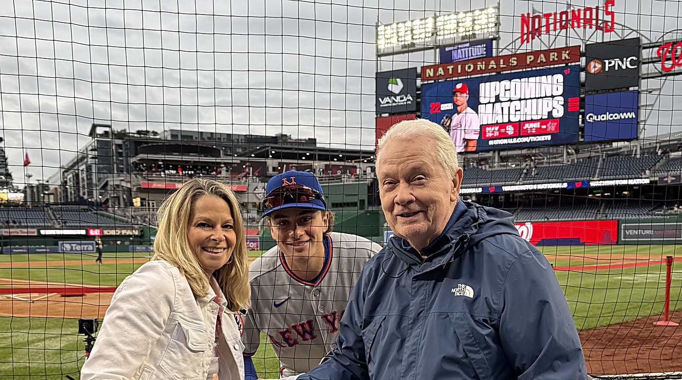 Carrie Blewitt posing with family at Nationals Park, a baseball player in a New York Mets uniform between them