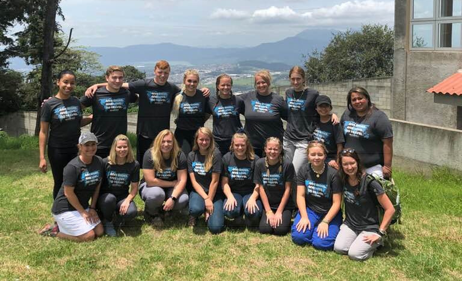 Carrie Blewitt volunteering with Soles4Souls, a group in matching shirts on a hillside